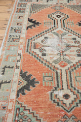 Distressed cinnabar red pile and geometric motifs with seafoam green on a vintage Oushak rug.