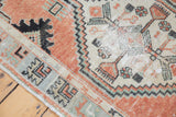 Worn geometric patterns and distressed texture of vintage Oushak runner, with cinnabar and pistachio.