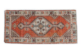 Distressed vintage Oushak runner with brick red field, stepped diamond medallion, 2'5
