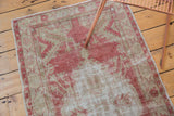 Soft, even wear on a distressed vintage Oushak rug in faded raspberry and beige.
