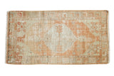 Distressed vintage Oushak rug with a faded pale tangerine medallion and ivory field.