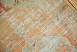 Tangerine orange, silver, and ivory distressed Oushak rug pile with mostly even wear.