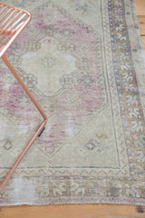 Distressed lower edge of Oushak rug with low pile, short fringe, and zig-zag border.