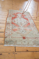 Short ivory fringe and lower border with faded geometric motifs on vintage Oushak runner.