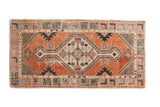 Distressed vintage Oushak runner with faded cherry red, antique ivory, and slate blue patterns.