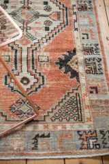 Abrashed border with primitive geometric motifs and worn pile on vintage Oushak rug.