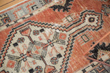 Faint foundation showing through faded cherry red, antique ivory, and slate blue Oushak patterns.