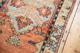 Distressed vintage Oushak runner with brick red border, serrated leaf patterns, and original side selvage.