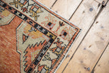 Distressed orange and beige Oushak rug border, showing even wear and intact selvage.
