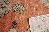Vintage Oushak rug's distressed orange pile texture and hand-knotted foundation.
