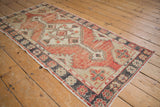 Distressed Oushak runner with abrashed charcoal and faded cherry floral border.