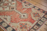 Abrashed cherry red field and primitive charcoal gray floral bud border of Oushak rug.