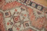 Distressed Oushak rug detail: faded red, ivory, and gray pile texture with primitive geometric border.