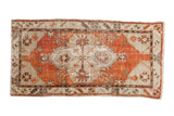 Vintage Distressed Oushak rug runner with geometric medallion and spandrels, faded brick red and beige, 2'6