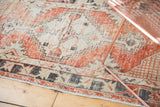Vintage distressed Oushak runner showcasing abrashed border design in faded cherry and ivory.