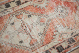 Distressed vintage Oushak rug showing faded cherry red and ivory abrash.