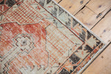 Distressed cherry red and ivory Oushak runner border with intact selvage.