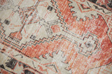 Distressed vintage Oushak rug detail with faded red, ivory primitive geometric drawing.