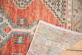 Distressed Oushak runner pile, geometric red and blue border, and hand-knotted reverse.
