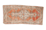 Distressed Vintage Oushak rug runner with faded cherry red field, diamond medallion, and abrashed geometric patterns, 2'6