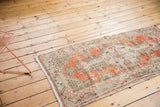 Distressed Oushak runner with faded cherry red, sea foam green, and ivory primitive floral border.