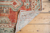 Distressed Oushak rug pile texture with exposed foundation and hand-knotted reverse.