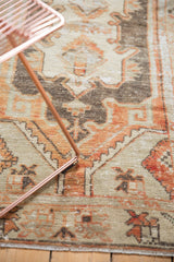 Distressed Oushak runner detail, unique terracotta and beige floral motifs, visible wear.