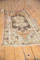 Distressed vintage Oushak runner with faded charcoal, terracotta, and sand colors, showing wear.
