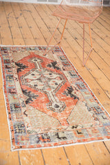 Distressed vintage Oushak runner corner, slate blue primitive floral border, even wear.