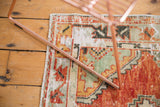 Distressed vintage Oushak runner pile, showing mostly even wear, etched texture, cherry red, and seafoam green.
