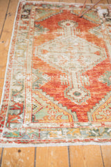 Distressed Oushak runner's border detail, playful floral buds, cherry red, seafoam, ivory fringe.