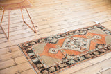 Vintage Oushak runner, faded brick red diamond medallion, ivory, and abrashed floral border.