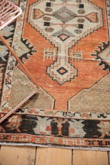 Distressed Oushak rug runner, fringed end with faded brick red and charcoal navy border.