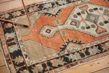 Distressed Oushak runner border with playful floral buds, cross-hatched spandrels, and abrashed pile.