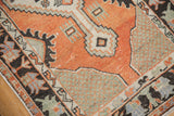 Distressed Oushak rug with faded brick red field, sage green spandrel, and primitive charcoal border.