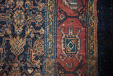 Unusual blue turtle design on the raspberry red main border of a vintage Bibikabad rug.