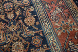 Hand-knotted Bibikabad carpet texture, showing indigo blue herati and raspberry red motifs.