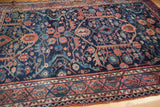 Vintage Lilihan rug lower corner, intricate borders, navy field, subtle wear, and faint stain.