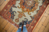 Antique Mission Malayer rug with ornate roundel medallion, ivory field, and bold red, orange, blue.