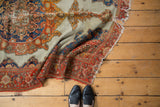 Hard tattered end with mostly secure selvage and red border of an antique Malayer rug.