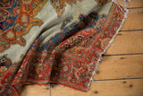 Antique Malayer rug's ornate bright tomato red floral border, ivory field, and worn fringe.