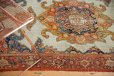 Intricate red border and distinct curvilinear motifs on an antique Persian Malayer rug.