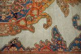 Antique Malayer rug’s ornate tangerine, tomato red, sky blue motifs on ivory ground.