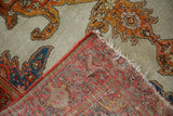 Tattered end, red selvage, and patterned reverse of the antique Malayer rug.