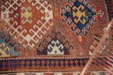 Original side cord selvage, navy geometric border, and light pile on an antique Kazak rug.