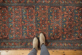 Vintage Mehrivan runner with feet, showcasing repeating floral design, even wear, and dusty blush, blue hues.