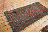 Vintage Mehrivan rug's repeating floral design, dusty blush and blue tones, with visible wear.