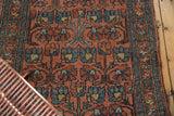 Repeating dusty blush and blue floral cross-section on vintage Mehrivan runner, with worn pile.