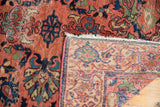 Vintage Malayer rug corner, showing low pile dusty rose front and hand knotted pale sand foundation.