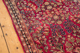 Vintage American Sarouk rug's raspberry red field, ivory and navy floral border.